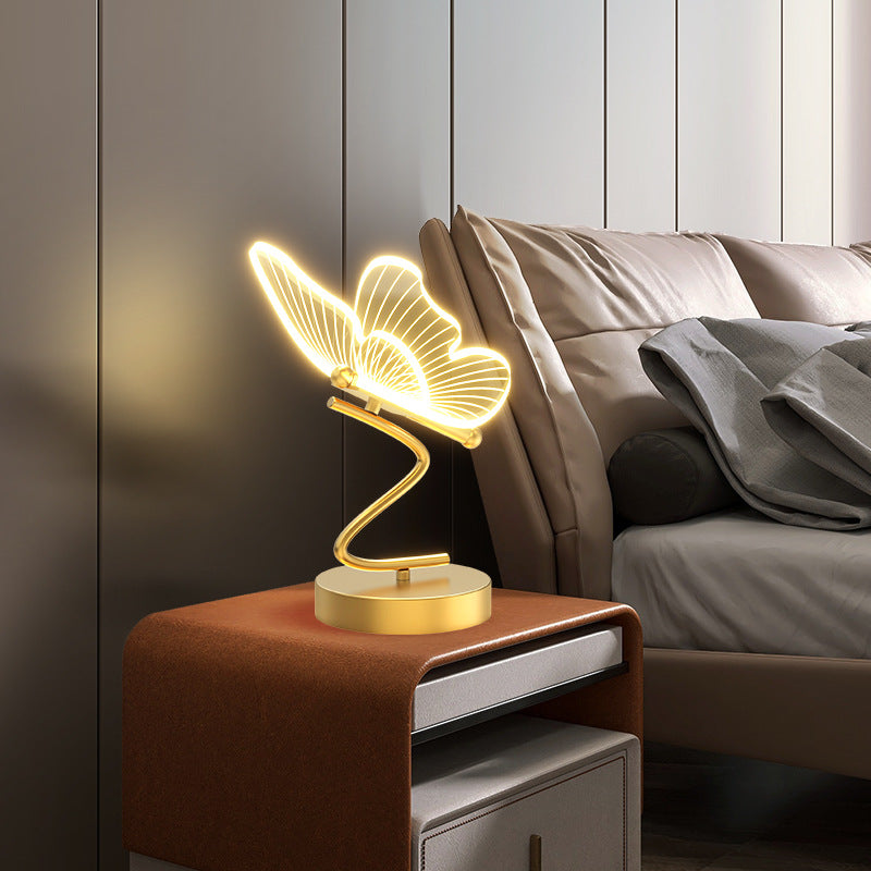 Nivesia butterfly LED decorative table lamp glowing on bedside table