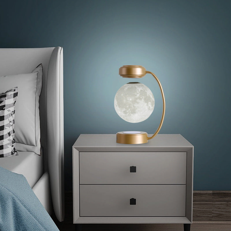 Nivesia levitating moon lamp floating above a gold base
